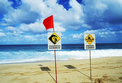 Summer travel safety tips include ocean safety rules if you head to the beach. 