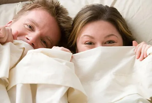 A couple having fun in bed.