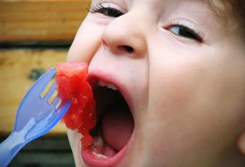 Photo of child eating fruit.