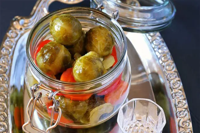 You can give your salads a kick by topping them with pickled Brussels sprouts flavored with hot red pepper flakes, mustard seed, celery seed, and turmeric.