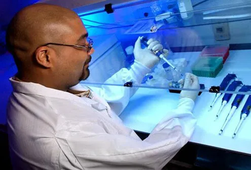 CDC biologist prepares mixture in laboratory.