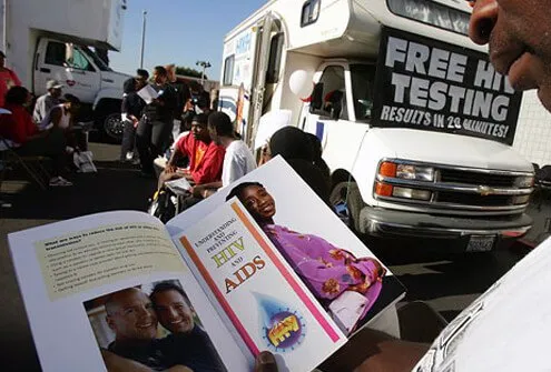 L.A. man reads an AIDS brochure as he waits for his HIV test results.