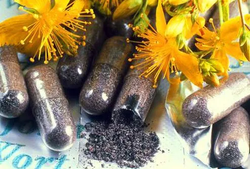 Pills and flowers of St. John's wort, an herbal remedy that may help treat mild depression.