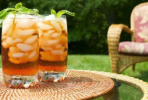 Two glasses of iced tea garnished with mint leaves.