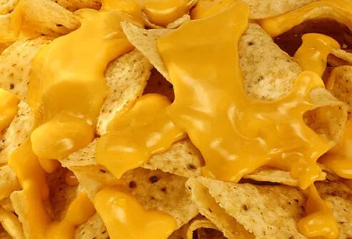 Corn chips covered in nacho cheese.