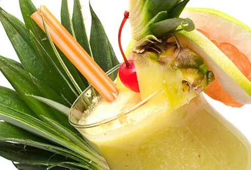 A blended piña colada garnished with pineapple and a cherry.