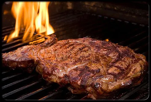 Steak being cooked on grill.