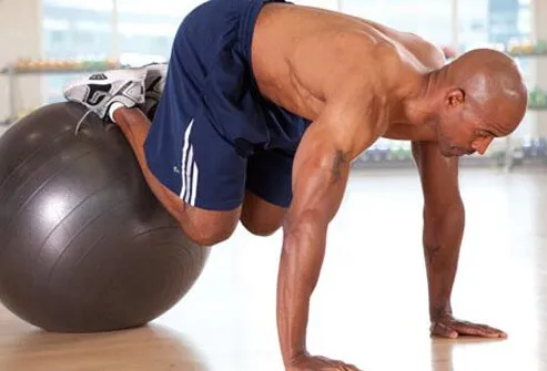 This move starts with your stomach on a stability ball, hands and feet on the floor.