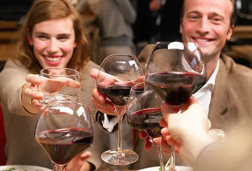 People celebrating drinking glasses of wine.