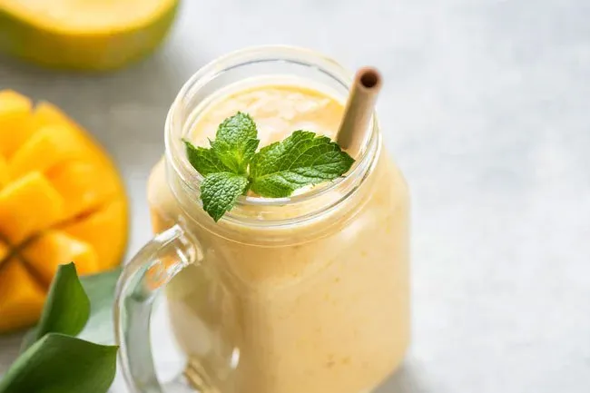 Add frozen chunks of mangos to make a smoothie. 