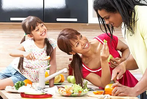 A family enjoying cooking together.