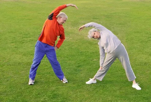 Senior couple performing stretching exercises.