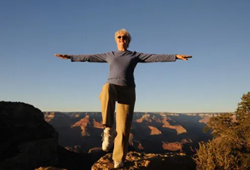 A woman balances and practices Tai Chi.