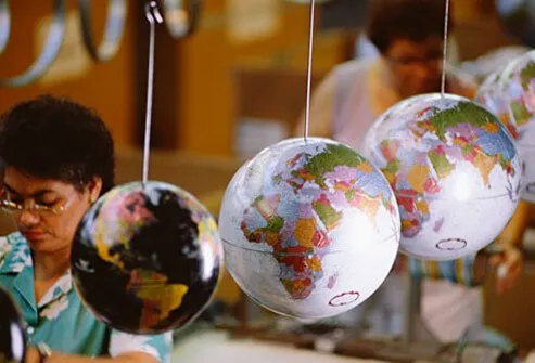 Photo of a factory workers making globes.