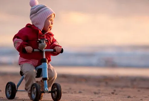 An infant riding her bike.