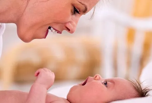 A mother talking to her baby.