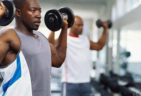 A man lifts weights in the gym.