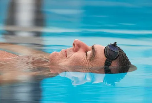 A man floats in a pool.