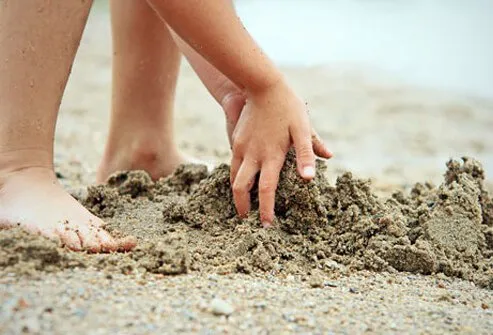 A child plays in the sand.