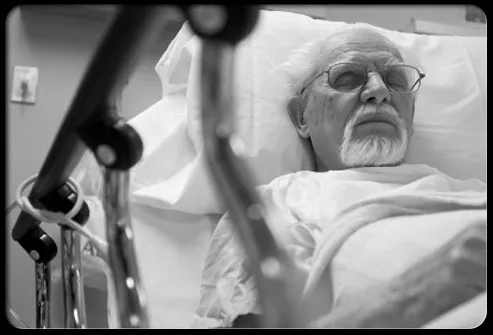 A patient rests in a hospital bed after pancreatic cancer radiation therapy.