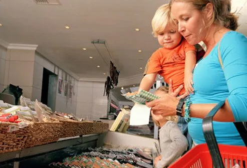 Mom looking at the sodium levels on some packaged deli meats.