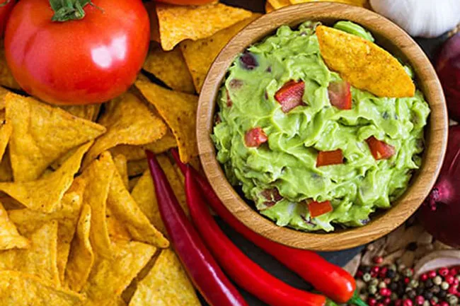 For a crunch craving, choose whole-grain, higher-fiber tortilla chips.