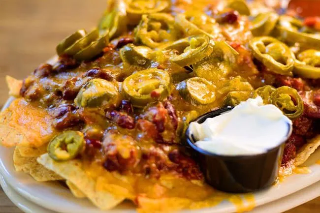 Nachos doused in fat, salt, cheese, beef, and sour cream are not a healthy food choice. 