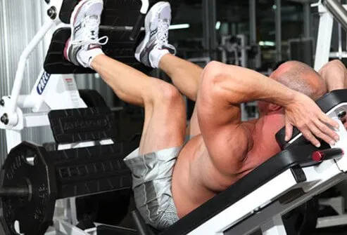 Photo of a man doing a leg press.