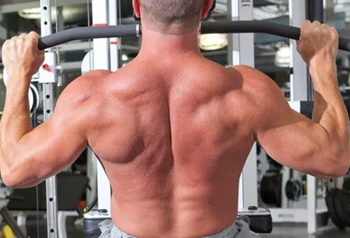 Sit on the pulldown machine and grasp the bar wider than shoulder-width.