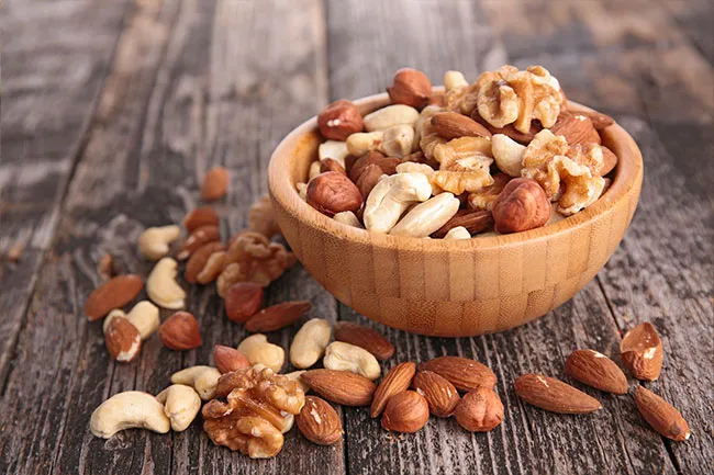 Peanuts are the nut with the greatest source of protein at 9 grams in a fourth of a cup.