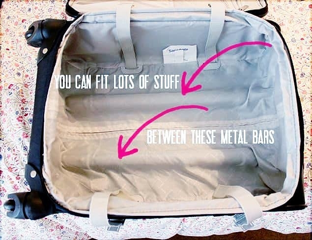 A photo of the space between the metal bars in a rolling suitcase