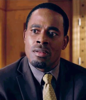 Lamman Rucker looks surprised in his tuxedo and tie