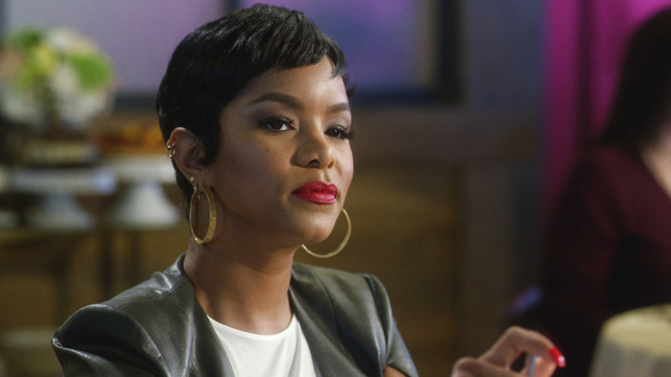 LeToya Luckett smirks with hoop earrings and bold lipstick