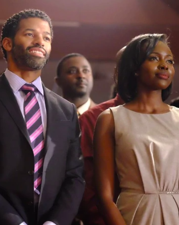 Benjamin Patterson and Anna Diop stand together, smiling in a sanctuary