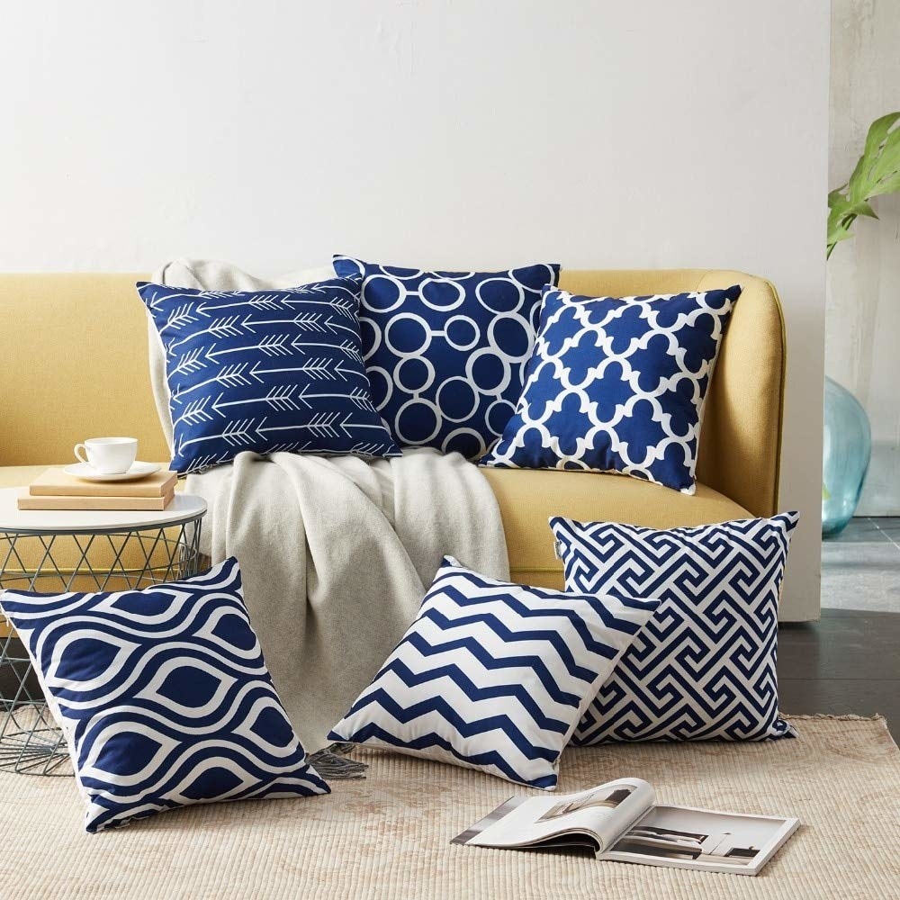 Blue pillow covers on a yellow sofa