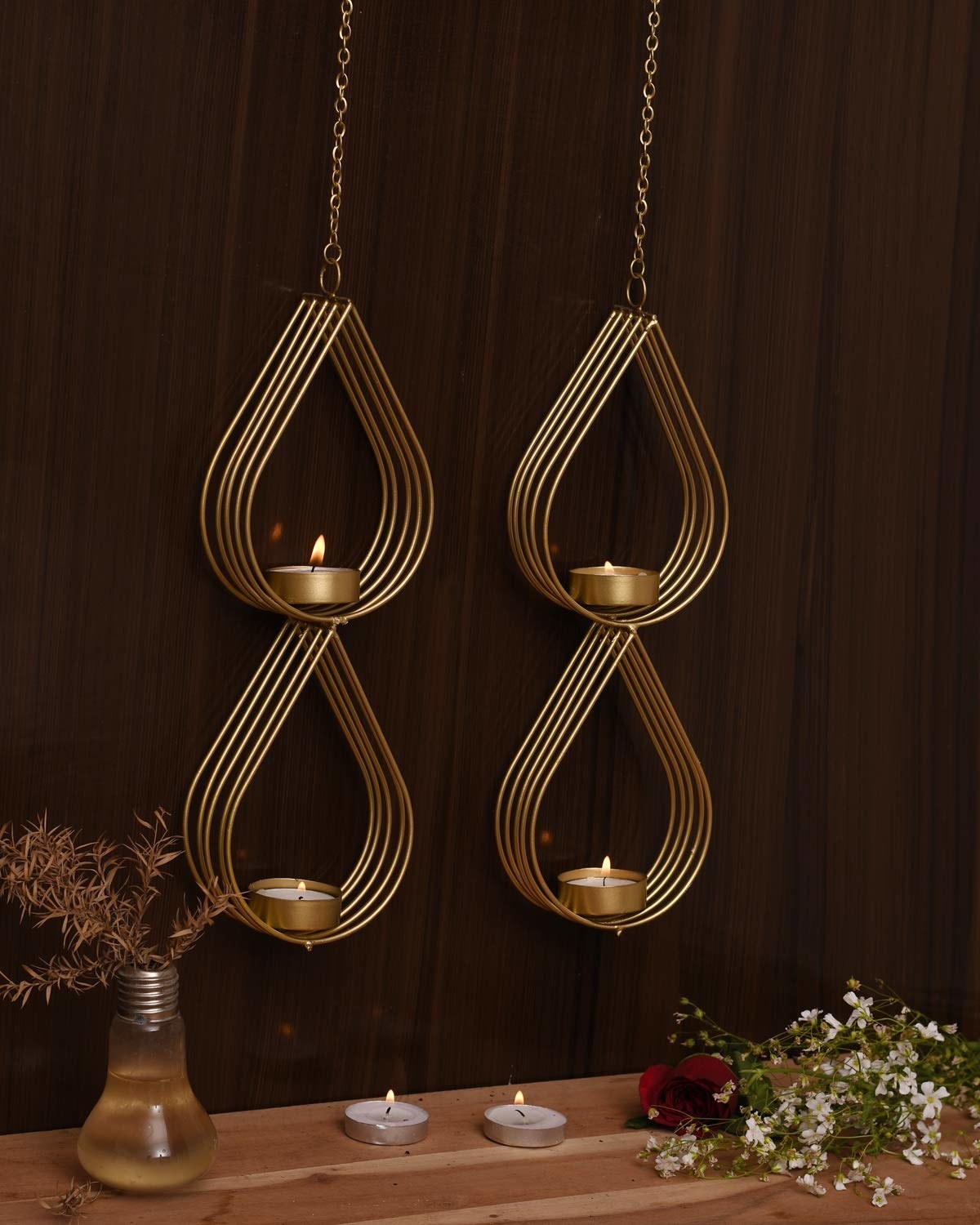 Four teardrop-shaped hanging candle holders.