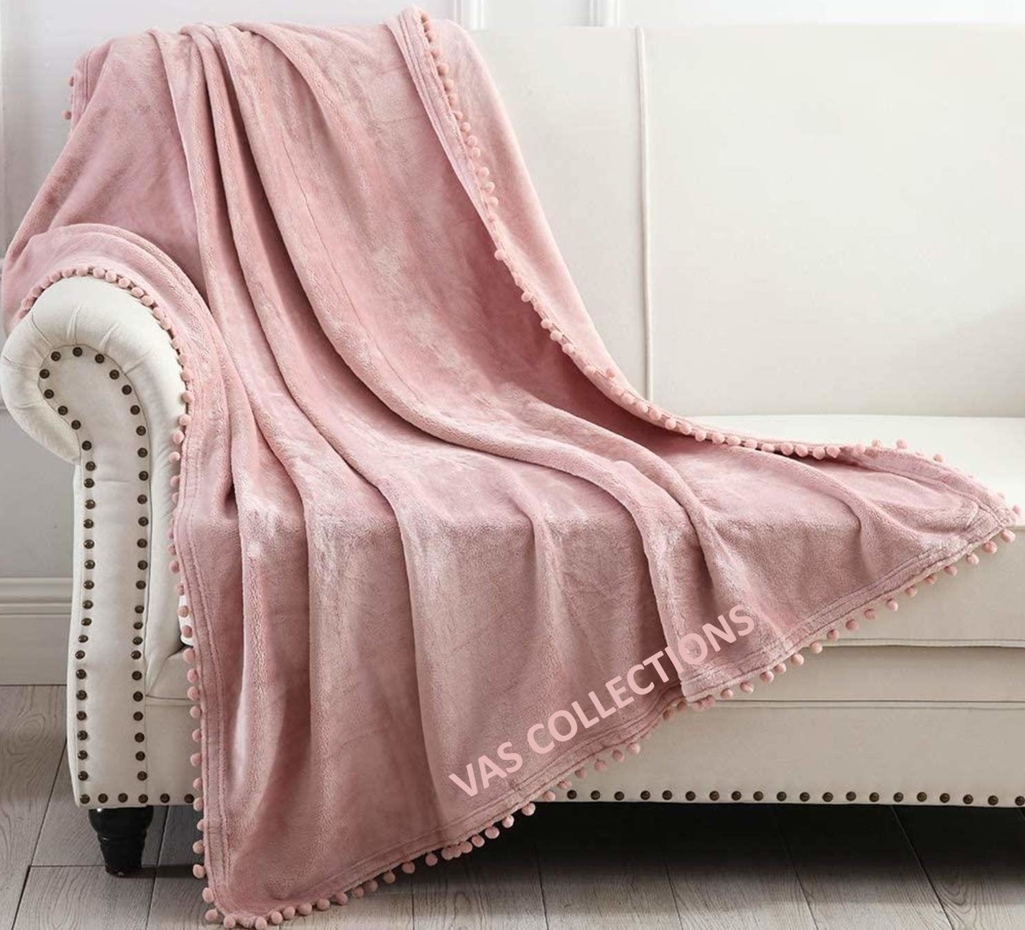 A pink throw blanket on a sofa