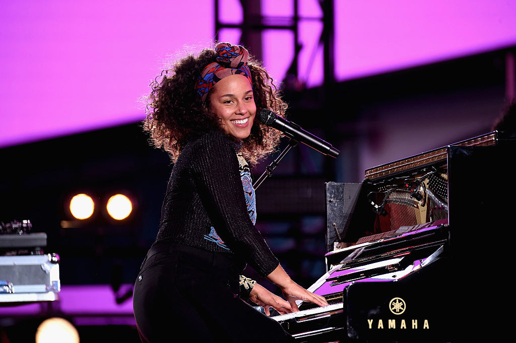 Keys performs on the piano in a concert