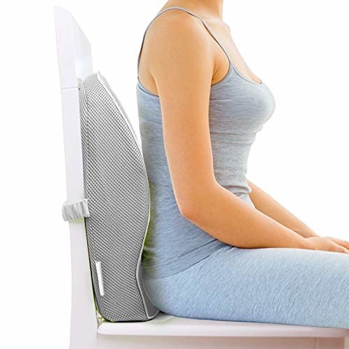 A woman sitting by a memory foam pillow