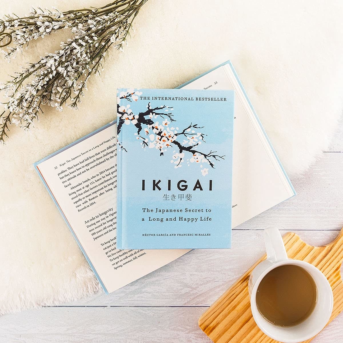 Ikigai on top of an open book next to a cup of coffee