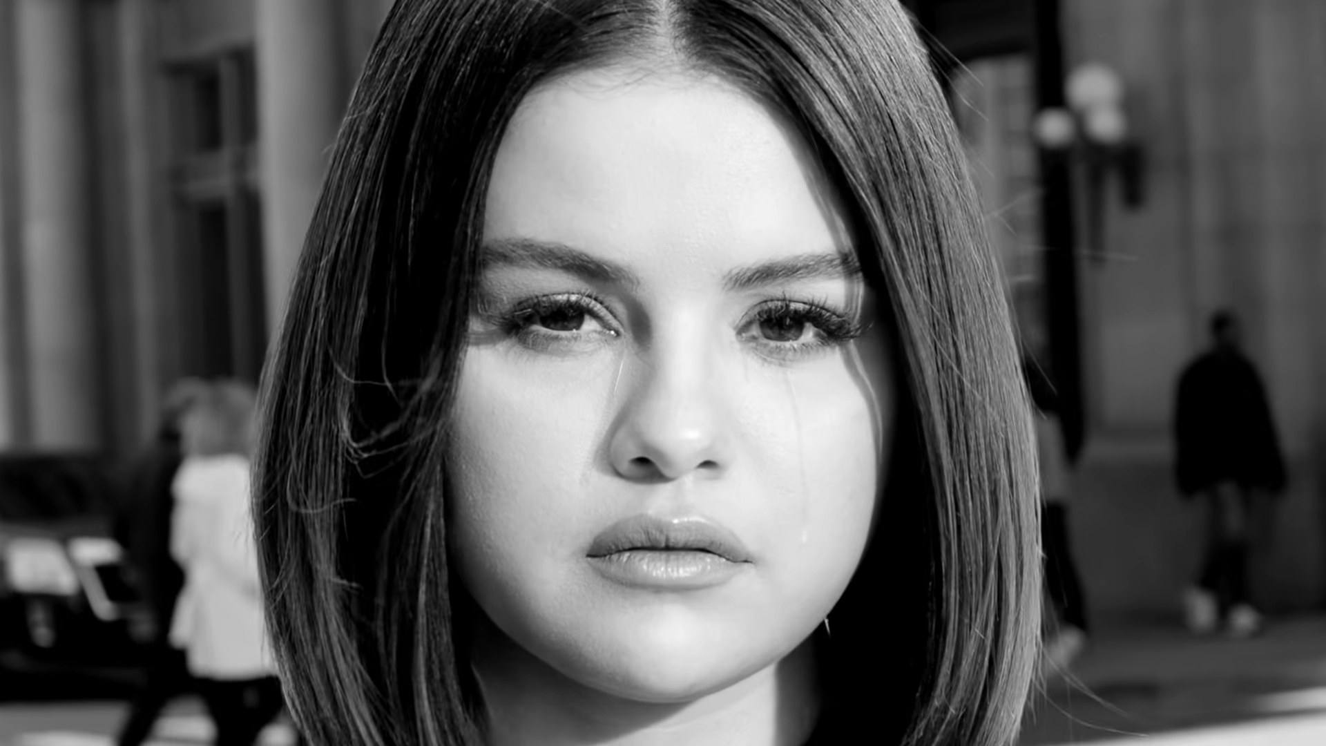 Black-and-white headshot of Selena looking serious