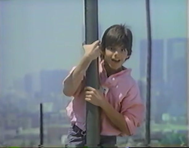 A teenage Ricky holding on to a pole