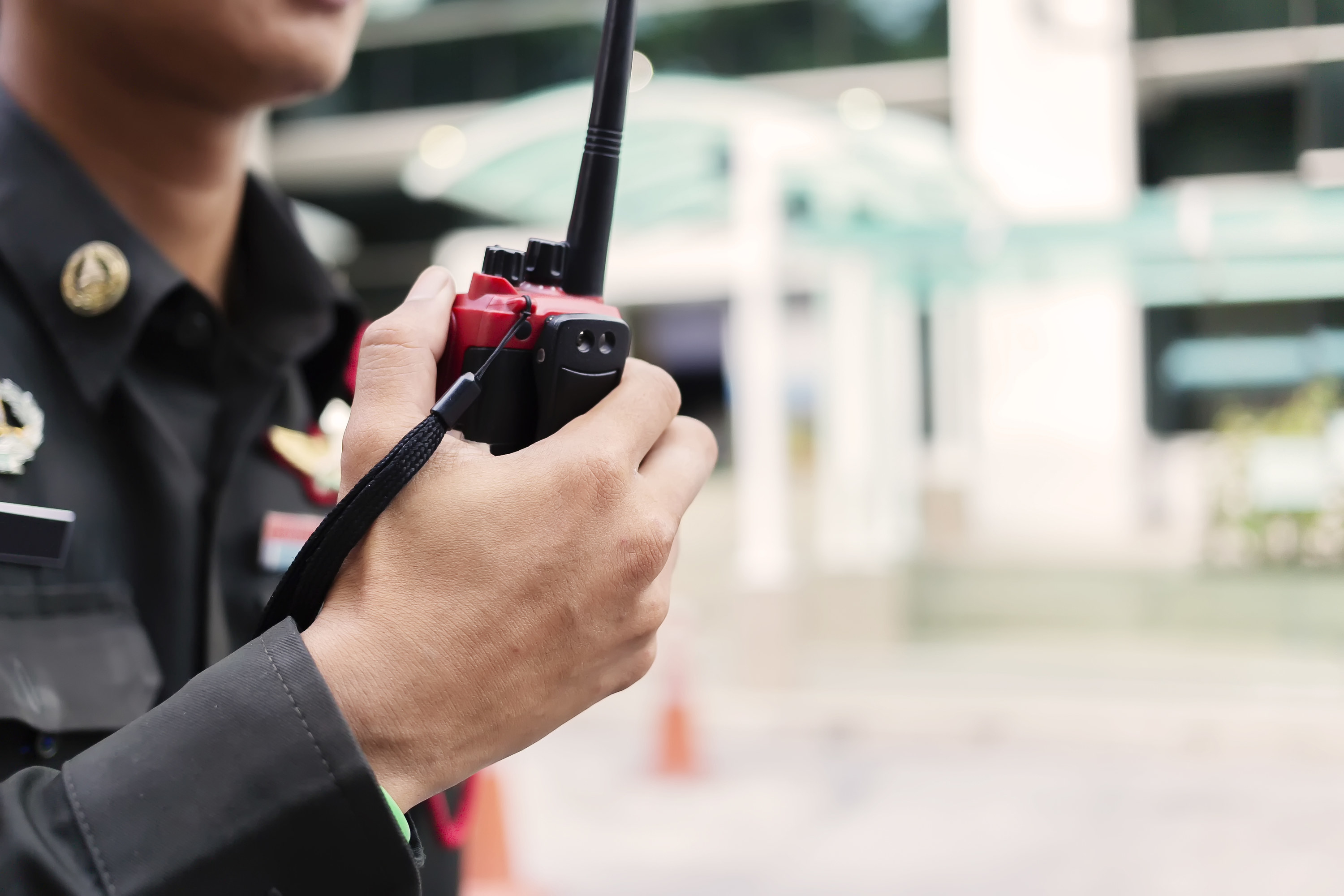 Police officer speaking into a walkie talkie