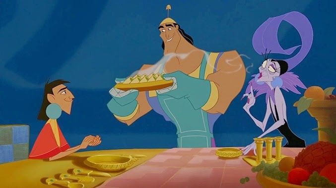 Kuzco, Kronk, and Yzma from The Emperor&#x27;s New Groove at a dining table. Kronk, in a chef&#x27;s apron and hat, serves food, while Kuzco and Yzma await the meal