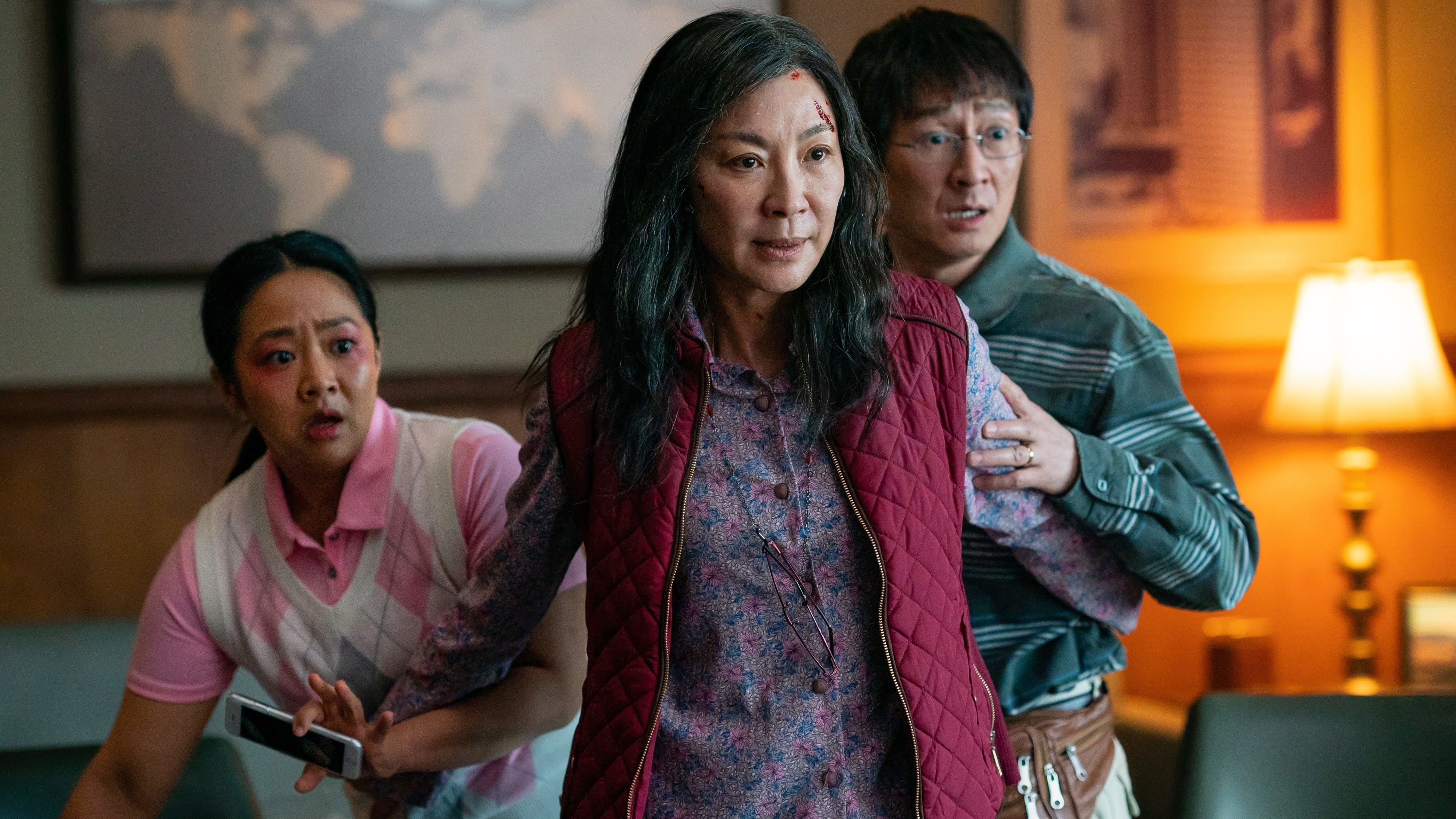 Stephanie Hsu, Michelle Yeoh, and Ke Huy Quan appear tense and apprehensive in a scene from &quot;Everything Everywhere All at Once.&quot;