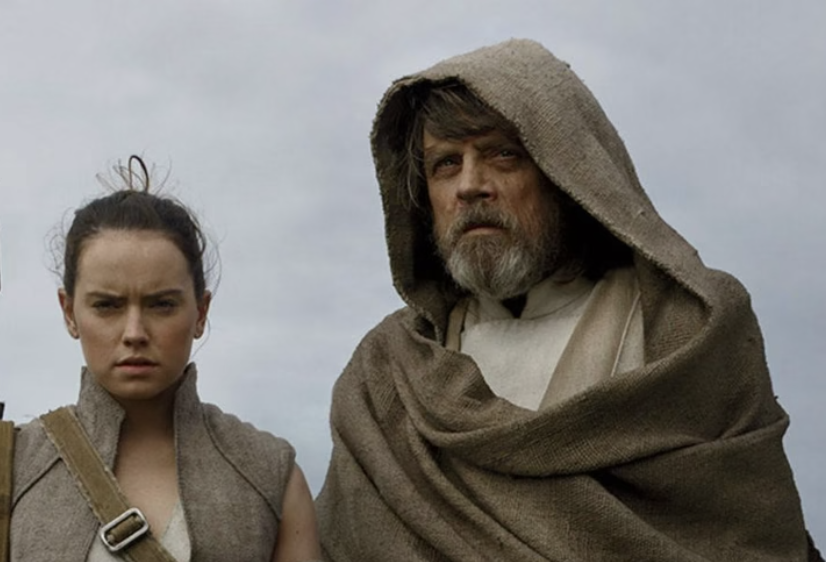 Rey and Luke Skywalker from Star Wars stand together, wearing rugged, desert-style clothing