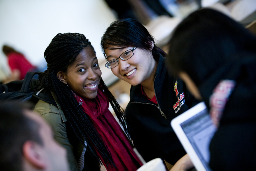 Diverse students on campus smiling