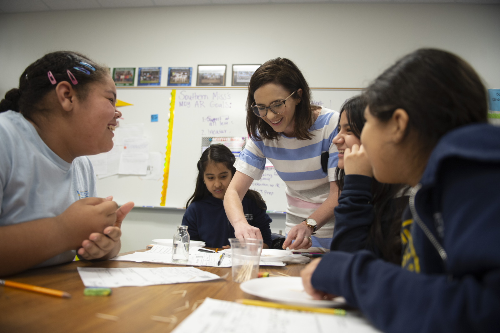 Teacher helping group of students