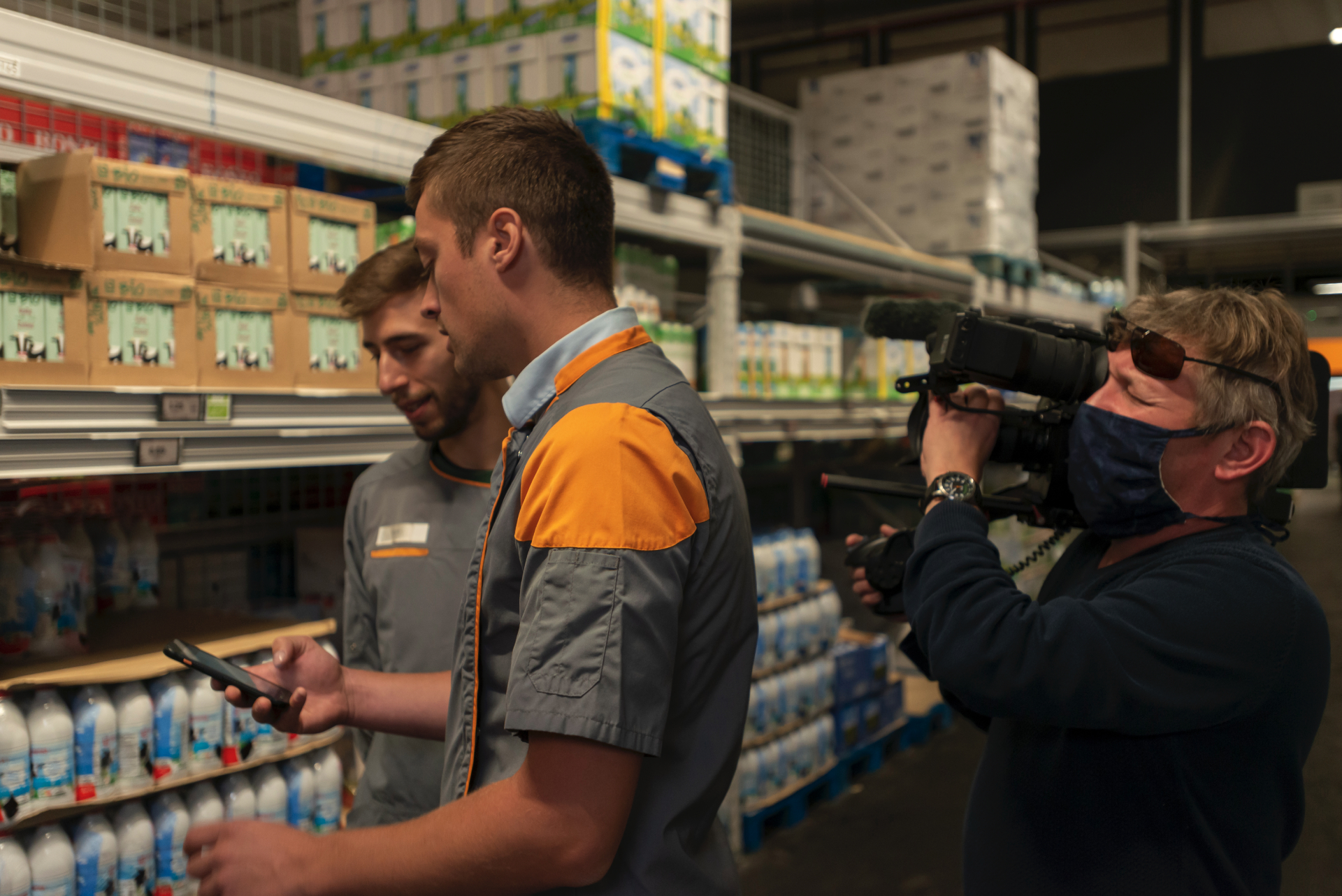 Two people in a retail setting looking at the screen on a mobile device