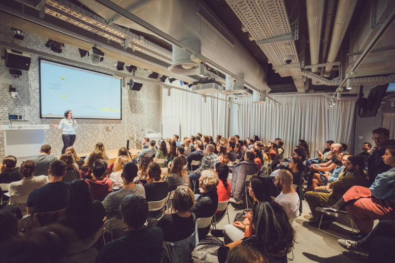 Man giving presentation in lecture hall at office